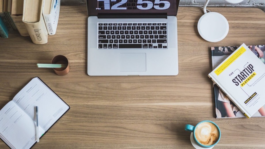 A laptop workspace with business books