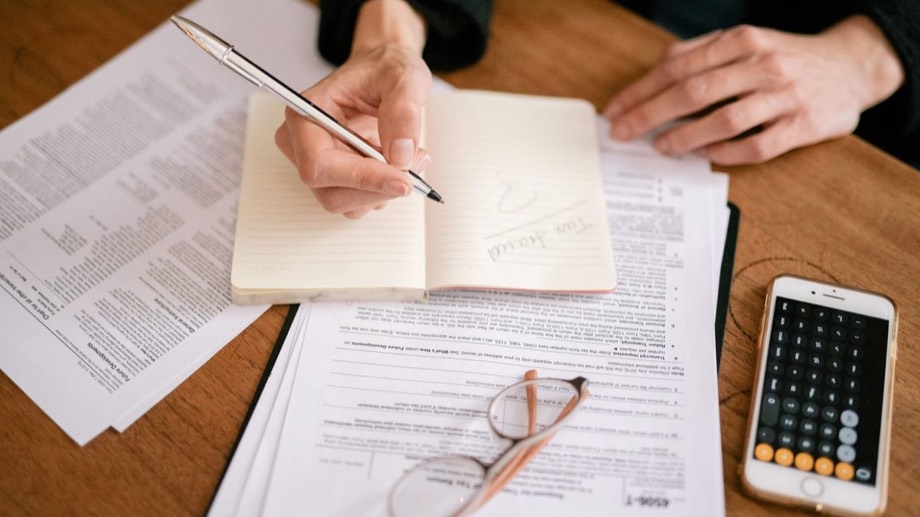 Making notes beside financial documents