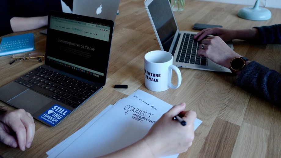 A team planning with laptops and notes