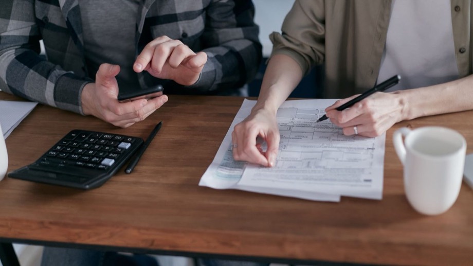 Two people working through forms