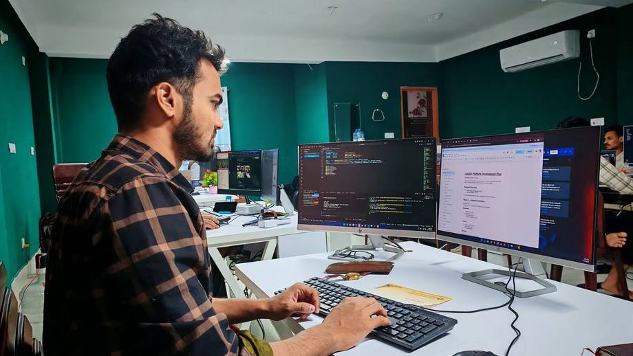 A developer working across two screens